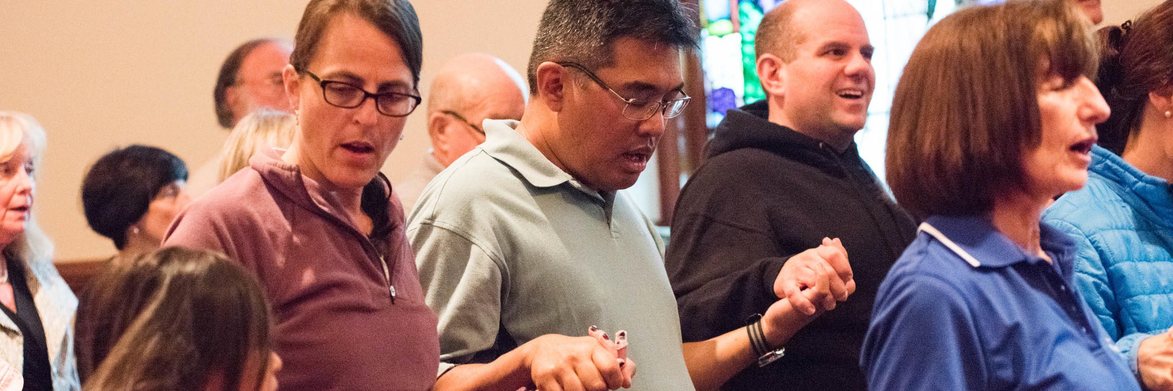 Visit page banner image - Holding hands in prayer